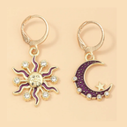 Sun and moon earrings with purple accents on a beige background